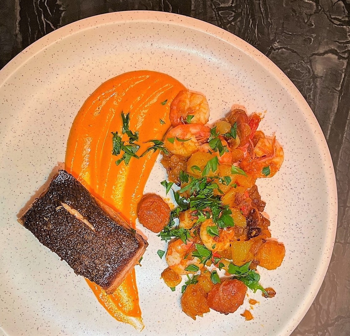 Salmon and prawns with chorizo sautéed potatoes, sauce Romesco