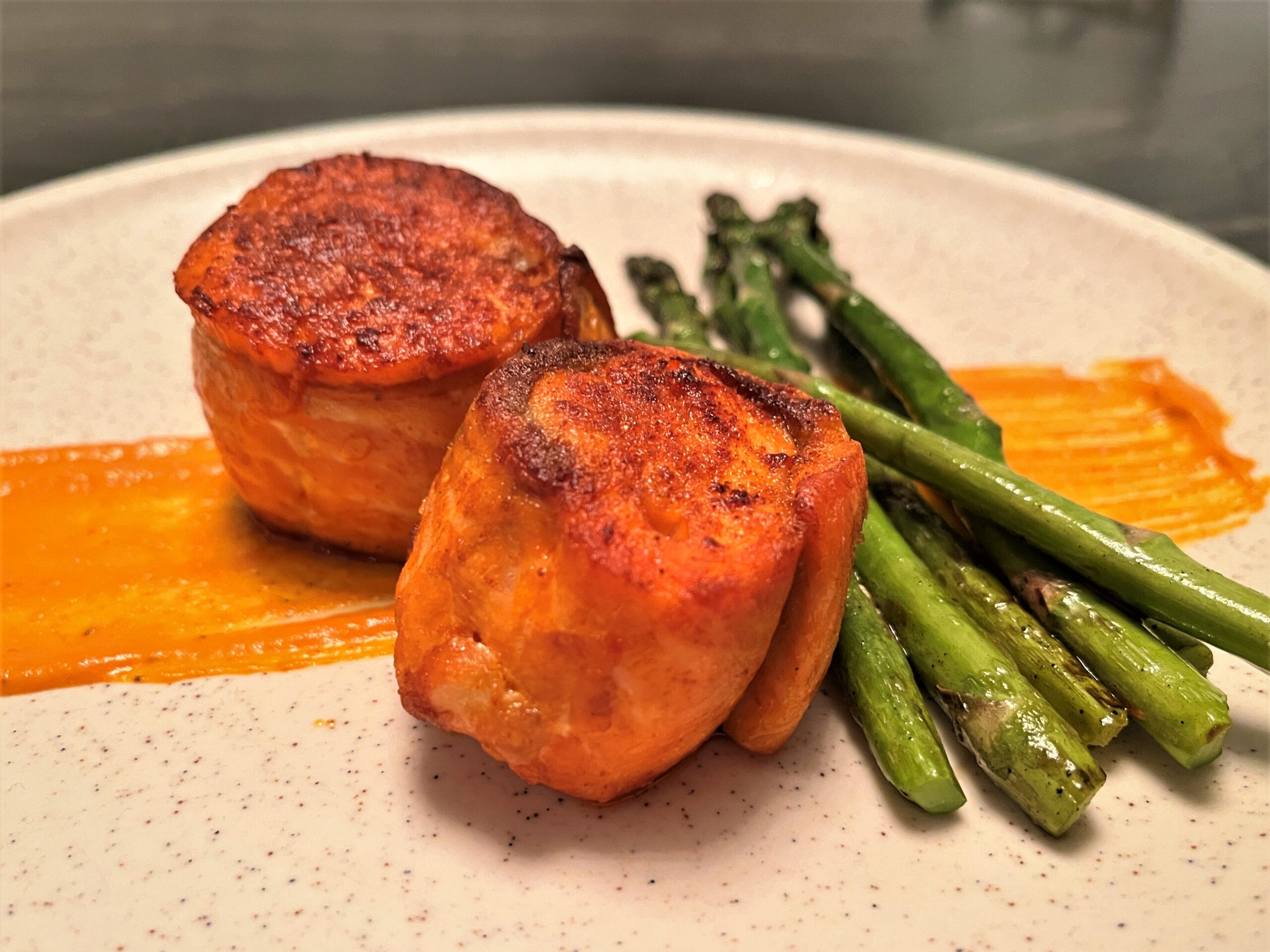 Steelhead Salmon roulade, grilled asparagus, sauce Romesco