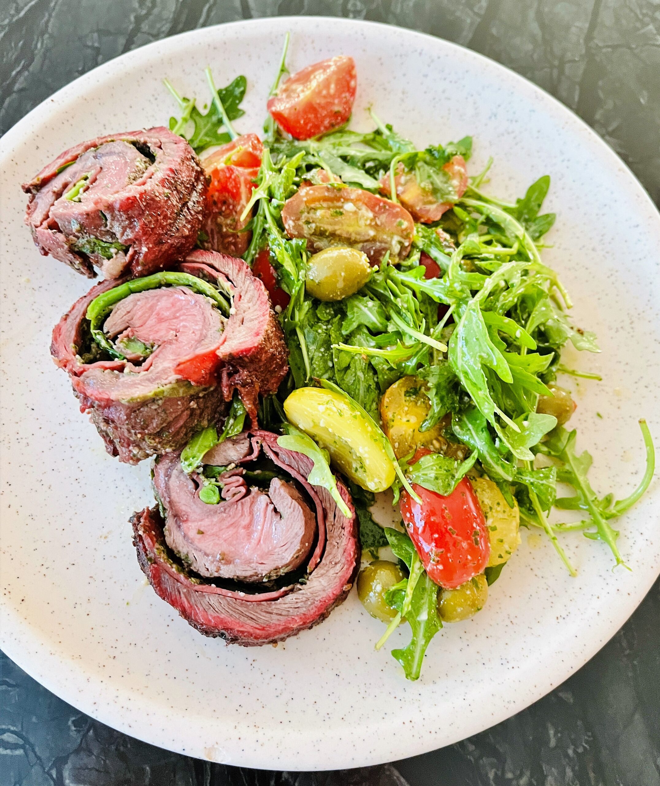 Experience the epitome of summer with our sizzling BBQ Flank Steak, peppery Arugula & Tomato Salad. A dollop of our homemade Arugula Pesto Dressing is an easy trick for quick and bold dressing. This dish is a breeze to prepare, ensuring you'll have more time to relish those long-awaited summer nights, filled with abundant food, endless conversations, and a river of flowing wine. For the perfect wine pairing that enhances but does not overpower the dish, uncork a bottle of full-bodied Merlot, Bordeaux or Northern Rhône Valley Shirah-Viogner blend and let the harmonious dance of flavours elevate your summer culinary experience.