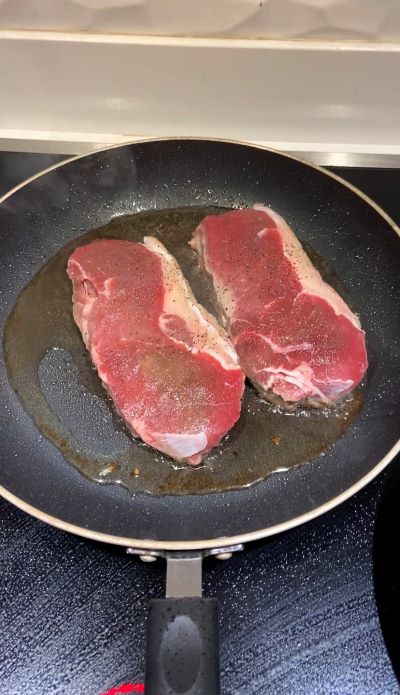 Heat oil in a pan and sear steaks