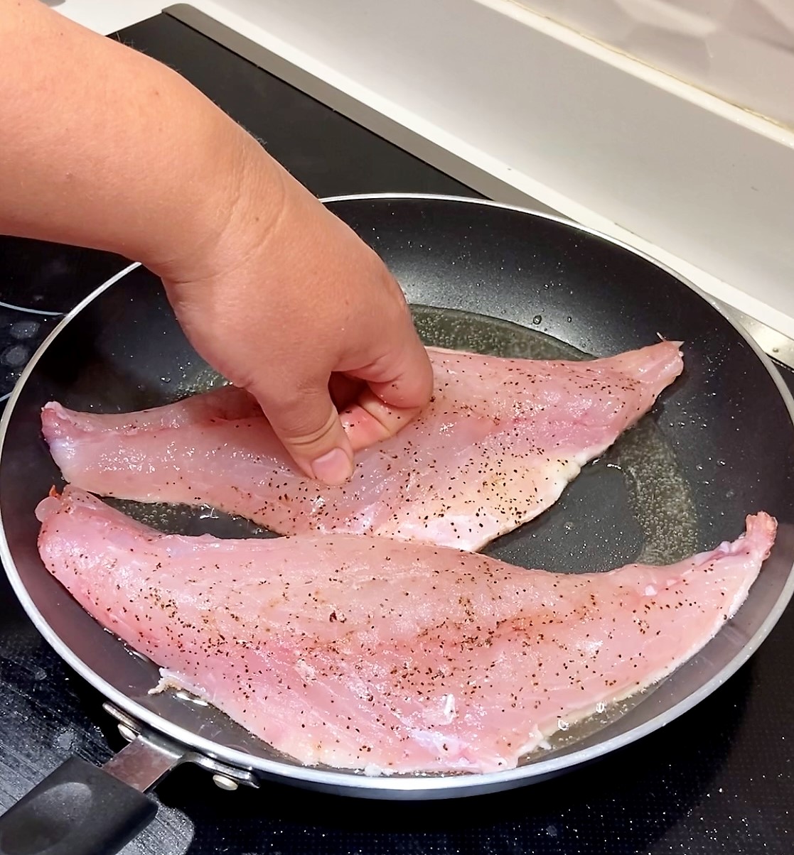 press red snapper fillets down to stop fish from curling