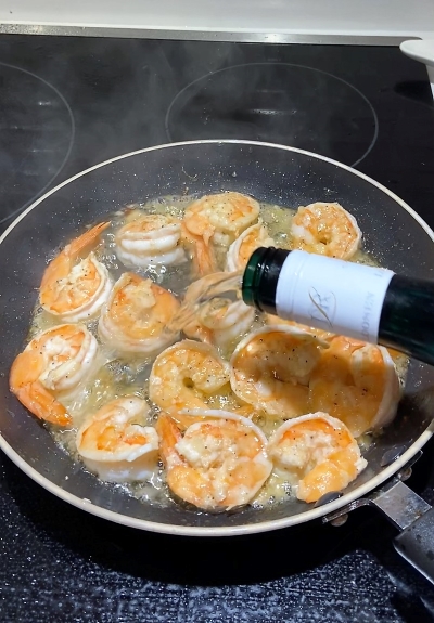 add white wine to the almost cooked shrimp