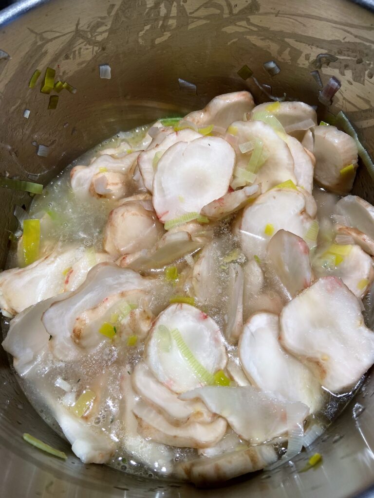 Add chicken broth to sunchoke soup