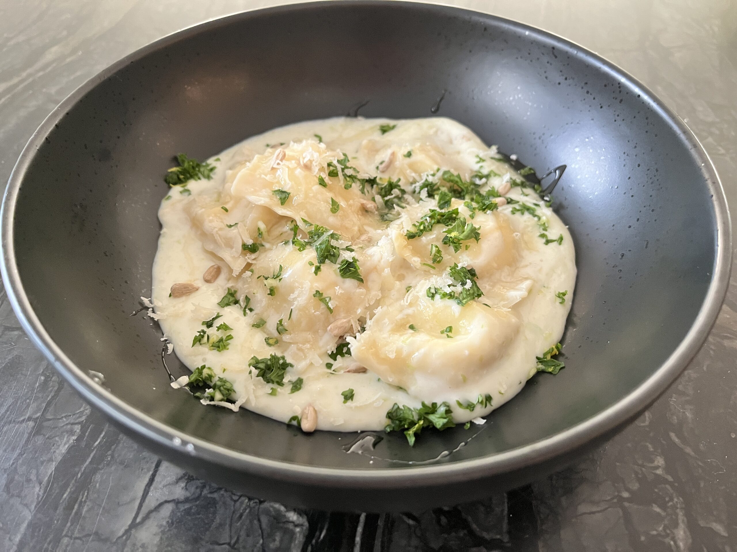 ricotta ravioli in soubise sauce and gremolata 