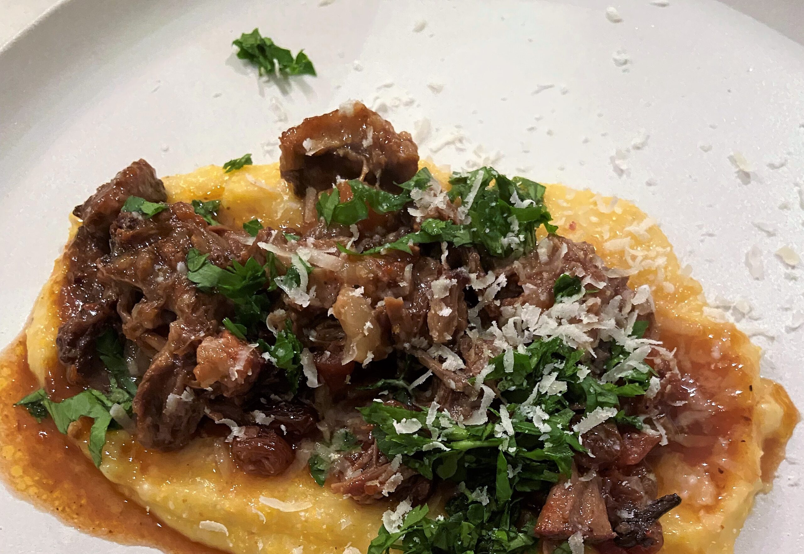 creamy polenta served with oxtail ragu