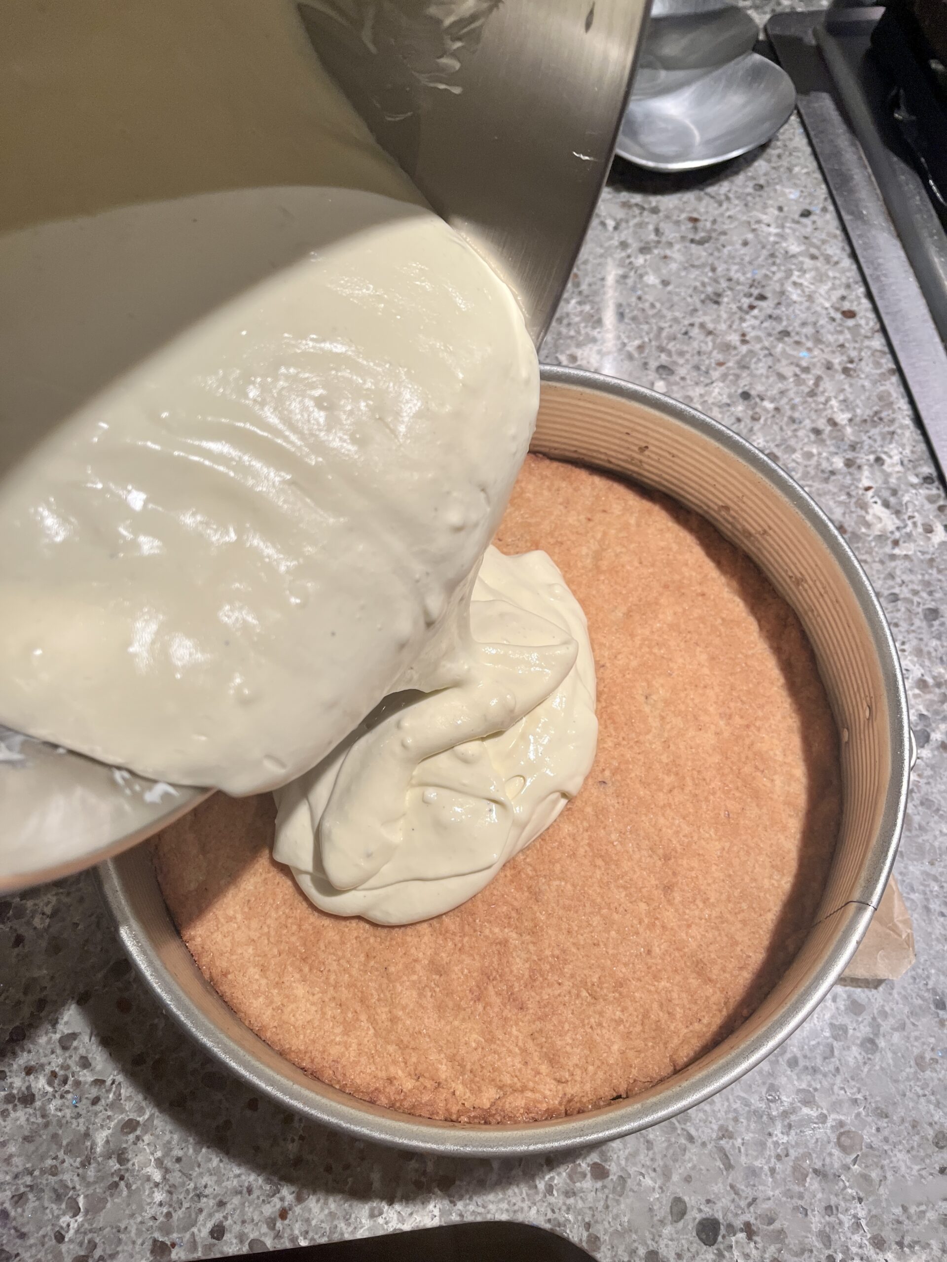 pour cheesecake mixture on top of the baked crust