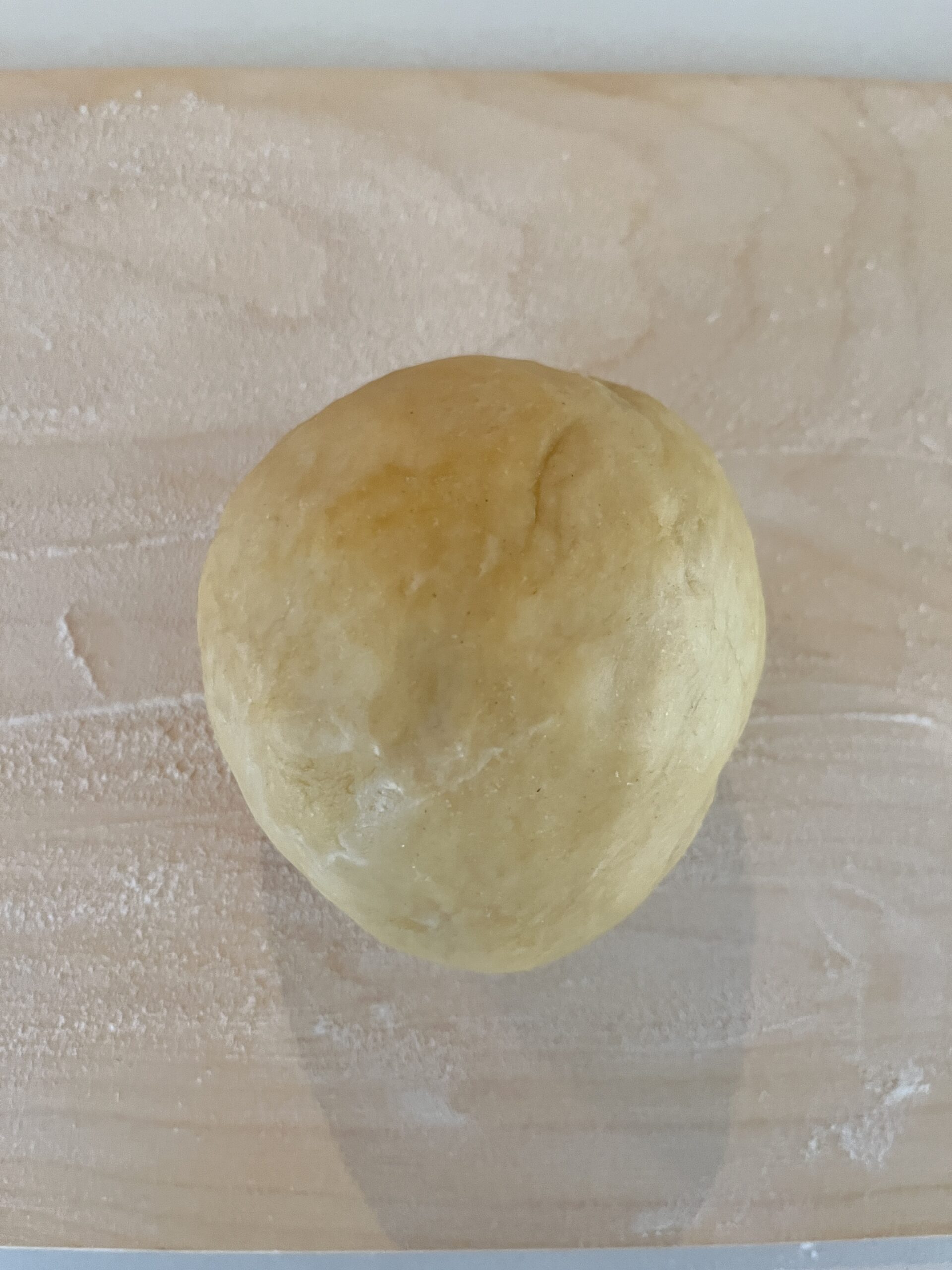 roll homemade tortellini dough into a ball